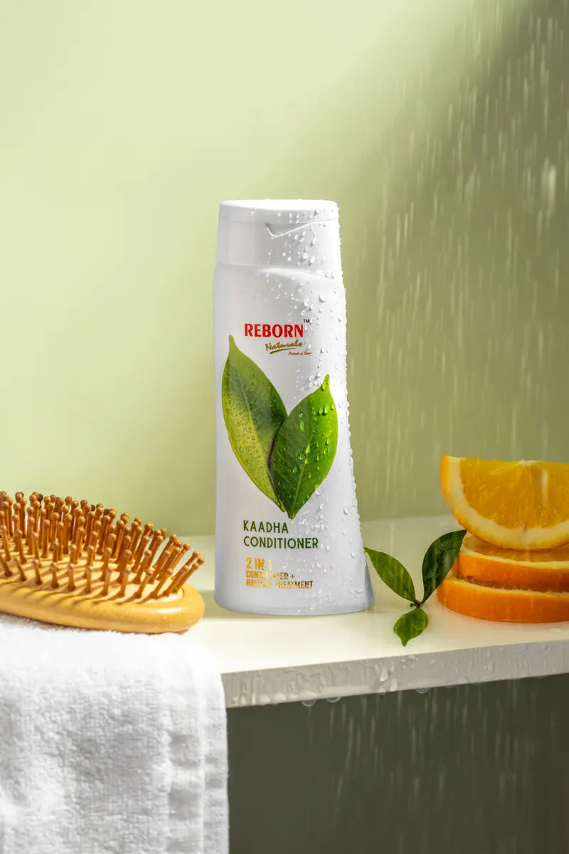 Kaadha Conditioner with a wooden brush and orange slices