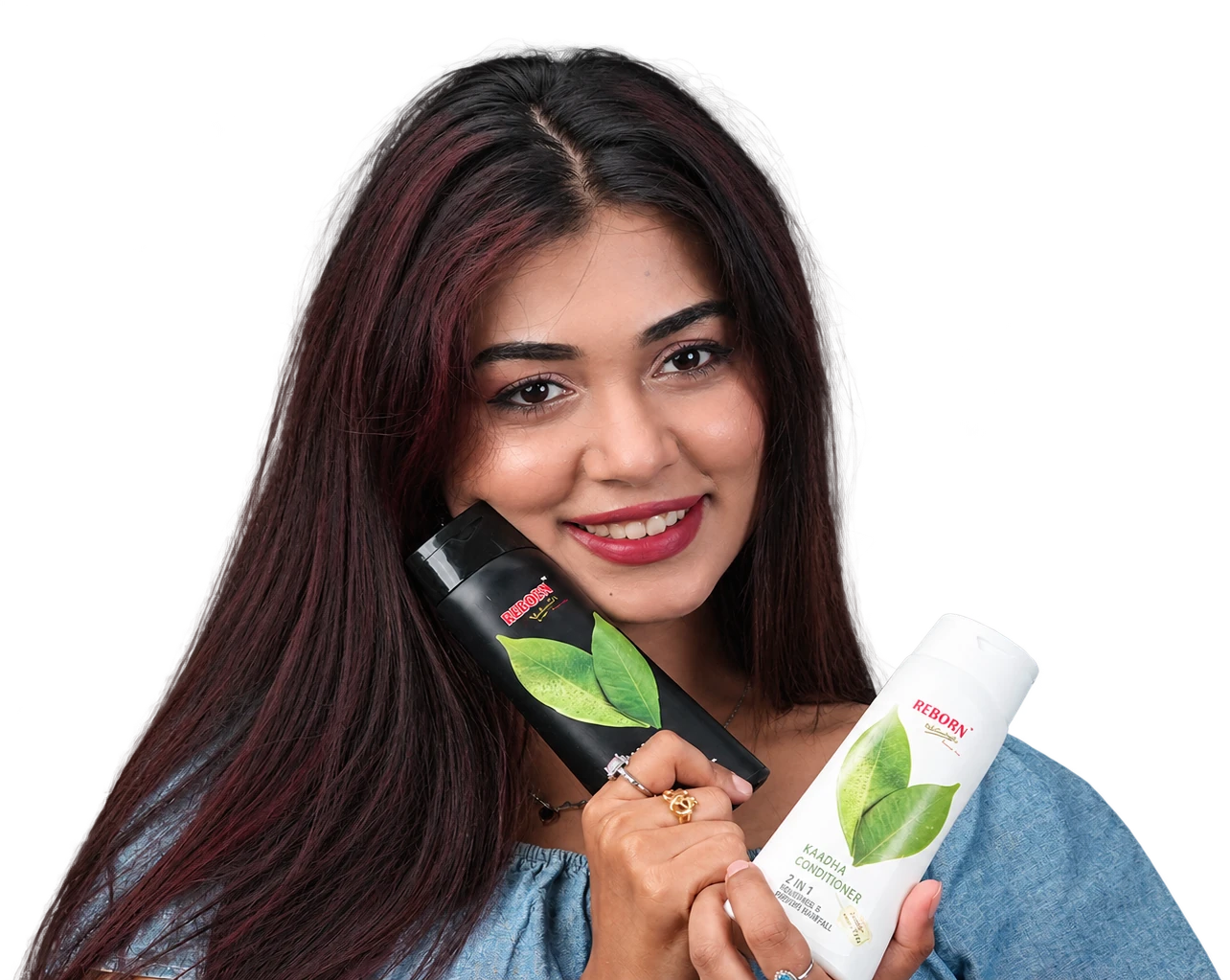 Smiling woman holding Kaadha Shampoo and Conditioner